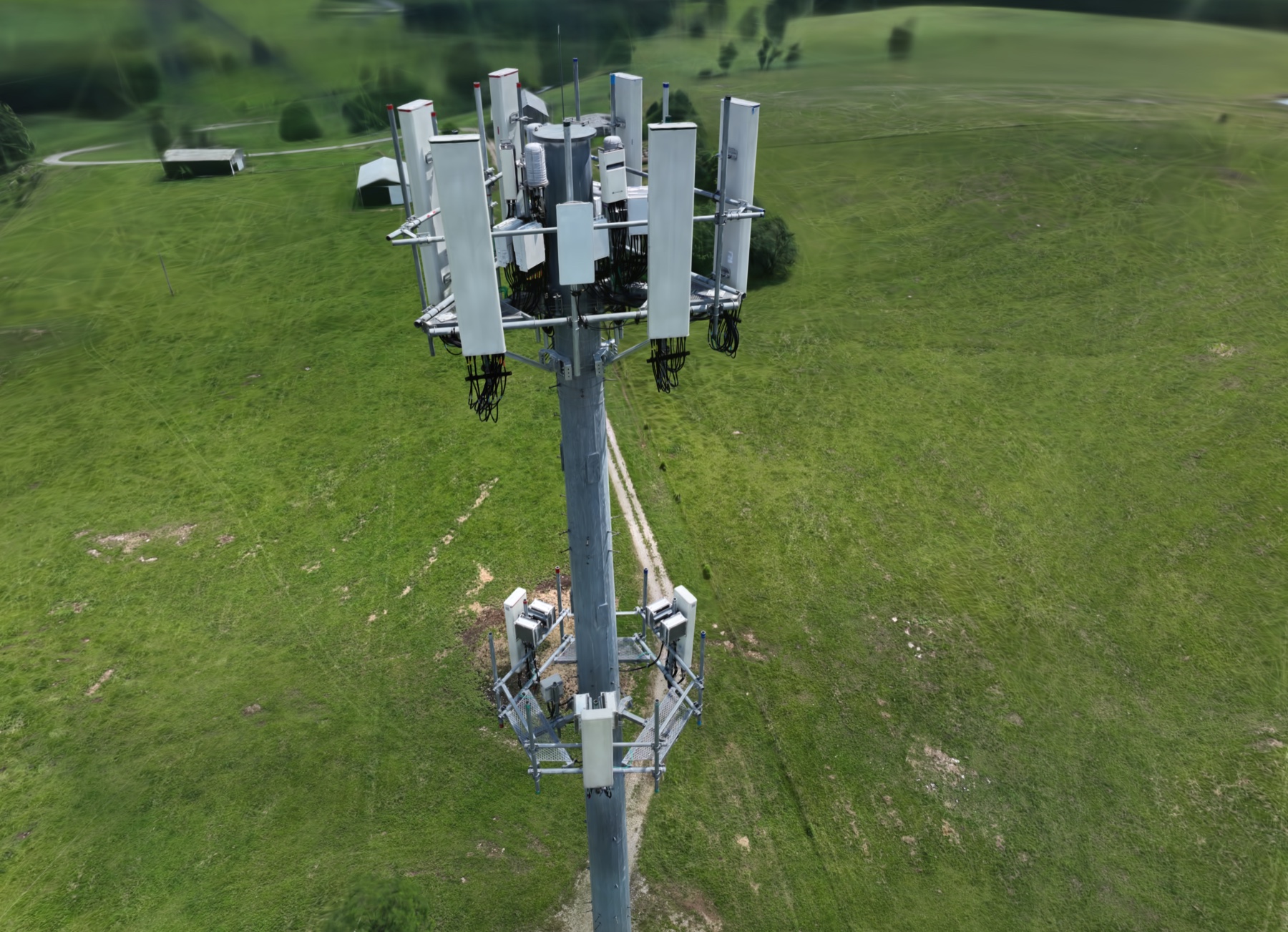 Gaussian digital twin render showing both equipment tiers of a cell tower